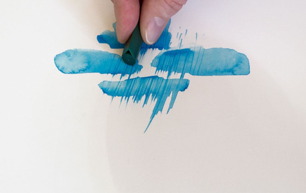 Scratching blue splotches of paint with the watertank brush cap.